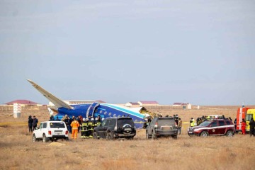 Especialistas inspecionam a fuselagam do Embraer 190, a oeste da cidade de Aktau: relatos de explosão -  (crédito: Kamilla Jumayeva/AFP)